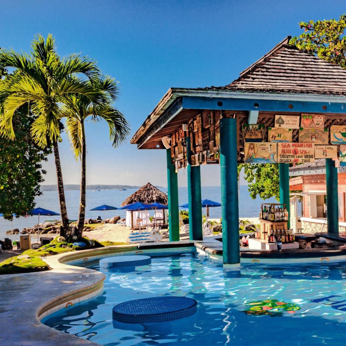 A view of a pool and the beach at Hedonism II resort in Jamaica. An all-inclusive, clothing-optional resort.